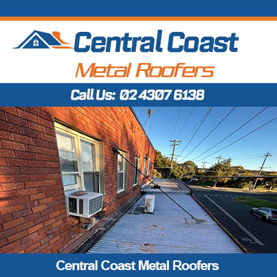 Metal roof replacement in progress on commercial building in Central Coast roofing project